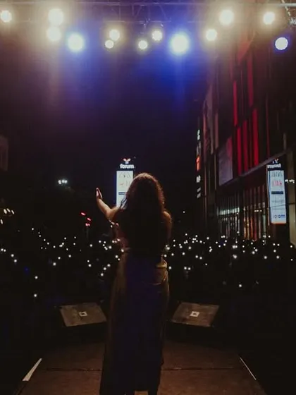 Facing a sea of lights from the audience's phones. It's a beautiful sight from the stage and shows how much everyone is connected to the moment.