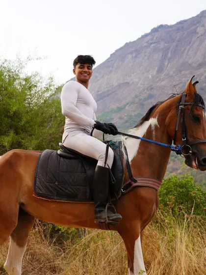 A rider on his striking paint horse, smiling for the camera during a break on our safari.