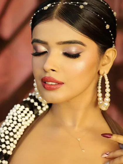A soft and dreamy close-up with eyes closed, emphasizing the delicate eyeshadow and highlighter.