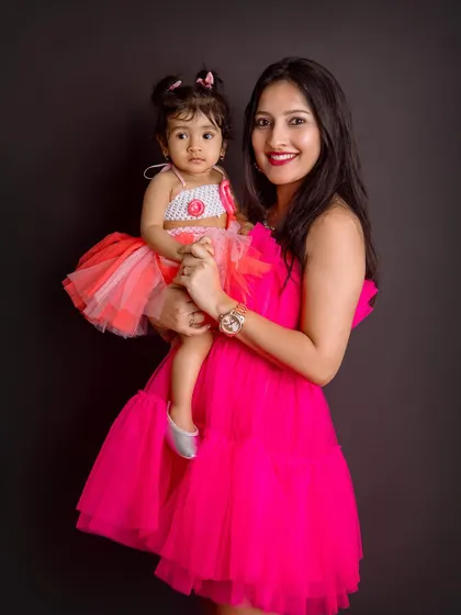 A classic mother-daughter portrait. The way she holds her little one shows so much love and affection.