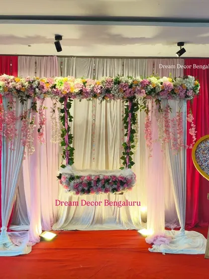 A full view of one of our most requested artificial flower setups for a naming ceremony. The package includes the backdrop, floral cradle, and the name reveal board.