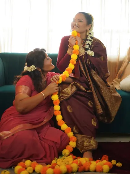 A playful and candid moment captured during the shoot, filled with laughter and festive flowers.