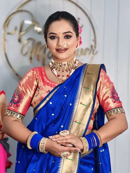 A portrait of the model in the royal blue saree, showing the perfect blend of traditional attire and modern makeup.
