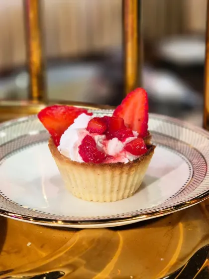 Another look at our classic Strawberry Tart, set against a warm, golden background. It's a simple yet elegant dessert that highlights the quality of our fresh ingredients.