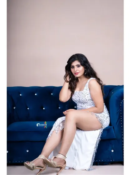 A full seated view of the white shimmer dress, perfect for a glamorous and bold photoshoot.