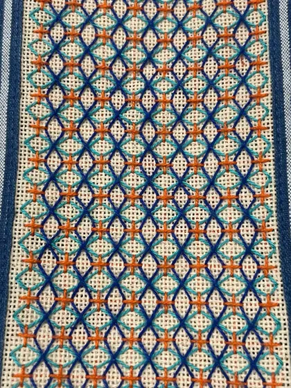 This custom phone insert features a geometric design with pops of orange, creating a striking contrast against the blue.