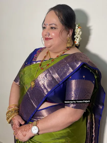 Another angle of Jyoshila's look, showing her beautiful smile and the elegant drape of her saree.