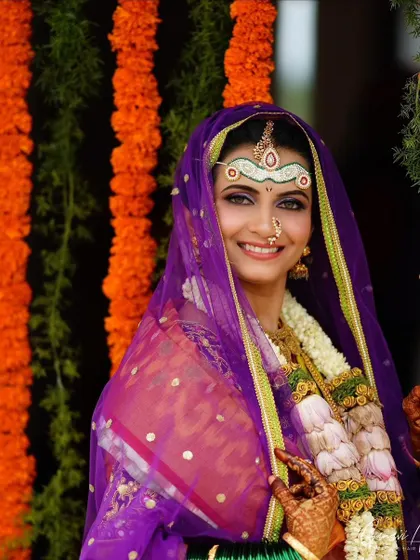 A beautiful shot of the bride during her ceremony. The traditional headpiece and nose ring are key elements of her look, enhanced by clean and defined makeup.