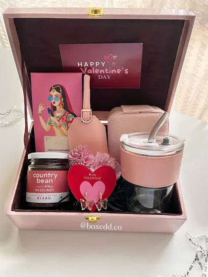 Our Valentine's Day hamper, curated in shades of pink. This trunk box is filled with a glass tumbler, a luggage tag, gourmet coffee, and other romantic goodies to celebrate the season of love.
