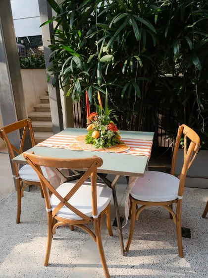 A styled seating area with a citrus-themed centerpiece, creating a cohesive look throughout the event space.