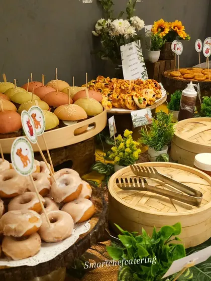 Another view of our Lion King-themed grazing table, with glazed donuts in the foreground and a variety of other delicious treats ready for the party guests.
