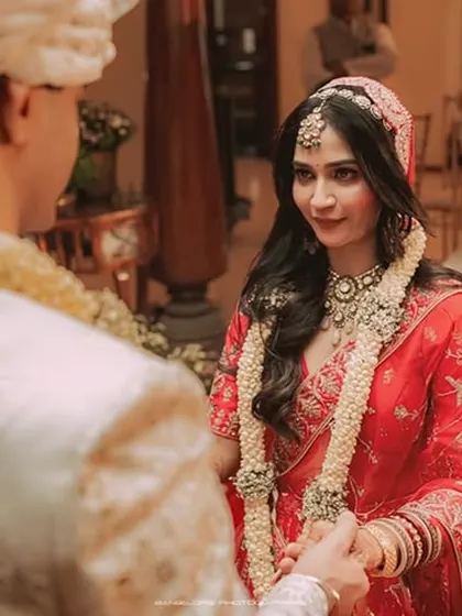 A tender moment between the bride and groom during their ceremony. The groom's loving gaze as he holds her hand is a testament to the story unfolding.