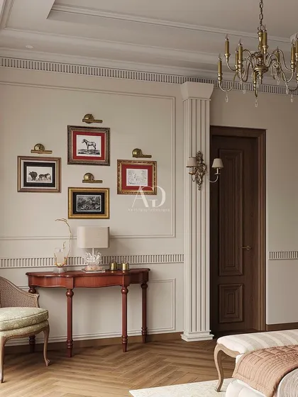 A detail shot showing the classic console table and gallery wall of equestrian art. These personal touches add character and a sense of history to the serene and muted bedroom.