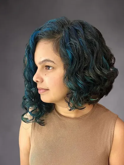 The blue highlights are painted on to follow the pattern of her curls.
