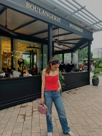A candid moment, looking down. The relaxed vibe of the outfit is perfect for everyday wear.