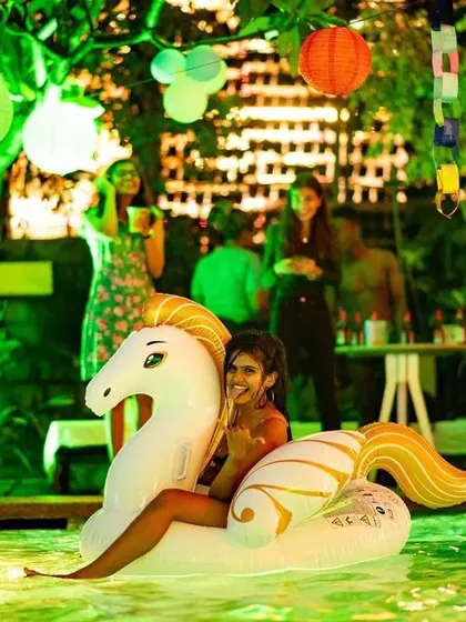 A guest riding an inflatable unicorn, adding a touch of fantasy to the pool party.