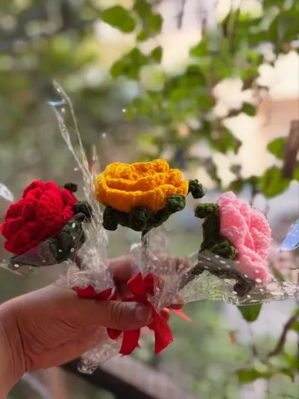 A collection of three single roses in red, yellow, and pink. You can mix and match colors to create a small, personalized bouquet.