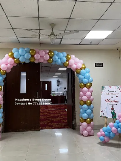 A classic balloon arch in pink, blue, and gold makes for a perfect entrance to a baby shower. I also provide a matching welcome board on an easel to greet your guests.