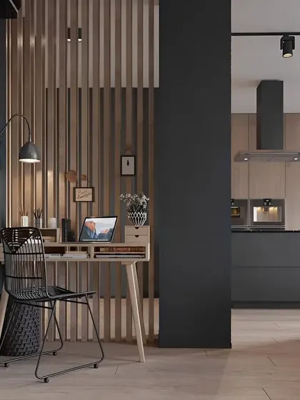 This study nook is cleverly tucked into a corner, separated by a wooden slat partition. The simple desk and wire-frame chair create a functional workspace that feels connected to the home yet offers enough privacy to focus.