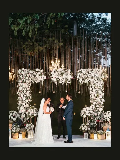 A wide shot of the stunning floral arch and altar where Gwen and Azhir said "I do" in an open garden ceremony.