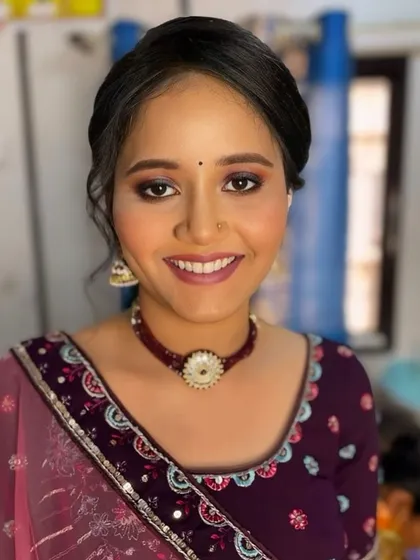 A happy and smiling portrait. The makeup is fresh and youthful, perfect for a wedding celebration.