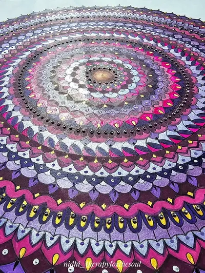 A close-up, angled shot of the magenta mandala, showing the texture of the paint and the small gold details I added to catch the light.