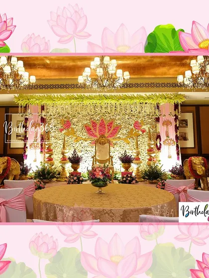 A wider view of the royal stage setup, showing how guest seating can be arranged around the main ceremonial area. The decor is consistent, with pink bows on chairs complementing the gold and floral stage design.