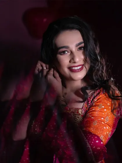 A creative portrait using motion blur to add a dynamic and artistic feel. The bride's smiling face remains the sharp, joyful focus of the image.