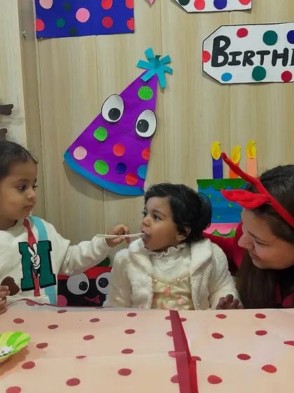 Another friend shares a bite of cake with the birthday girl, showing the caring community we foster.
