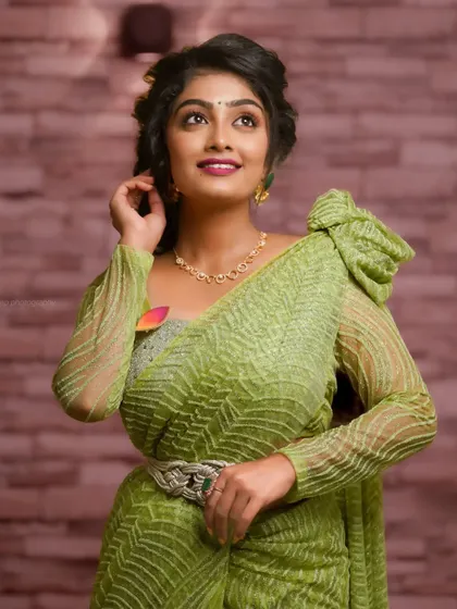 A three-quarter shot, showing the unique design of the saree and the elegant pose.