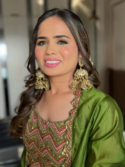 A close-up of the Mehendi makeup. The skin is flawless and radiant, and the eyes are softly defined to balance the bold outfit and heavy jewellery.