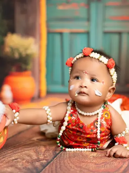 Caught in the act! A close-up of a baby enjoying the "butter" during our Little Krishna photoshoot. These playful moments make for the most memorable pictures.