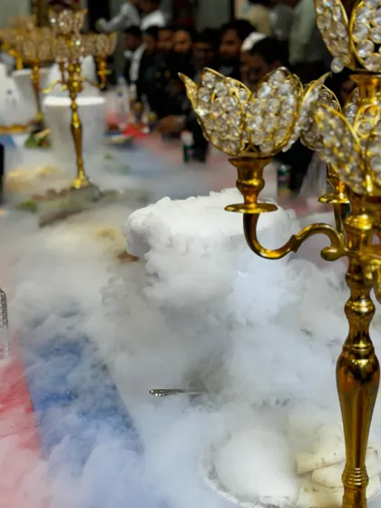 The golden candelabra stands tall amidst the flowing dry ice smoke, adding a touch of royalty and elegance to the dining experience.