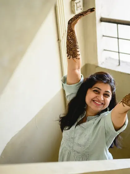 Poorva joyfully showing off her intricate bridal mehendi. Her happiness is absolutely contagious.