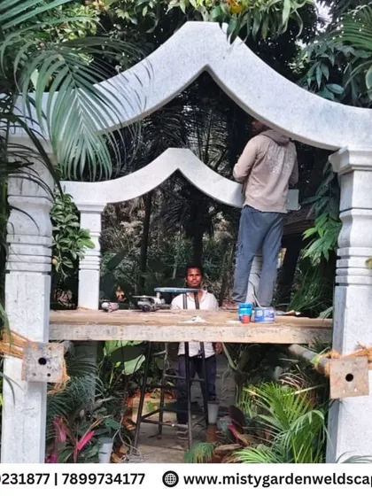 Our craftsmen at work, making final adjustments to the stone arch structure to ensure a perfect fit and a flawless finish.