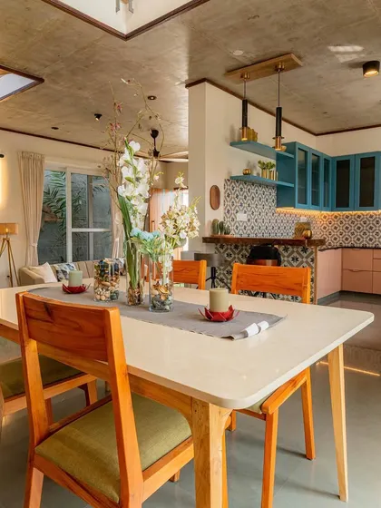 Another perspective of the dining area in 'The Valley', showing its relationship to the living space. The open, split-level layout creates a sense of spaciousness in a compact footprint.