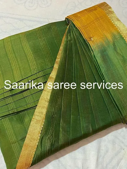 A simple and elegant green saree with a gold border. Perfect for a small gathering or puja.