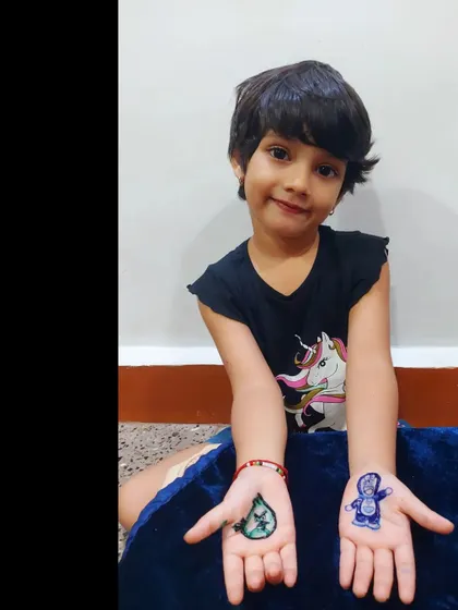 Another shot of my happy little client showing off her colorful Doraemon and Angry Bird henna.