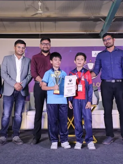 Young champions holding their trophy and certificate after a successful competition. We prepare our students not just to build robots, but to present their work and compete with confidence.