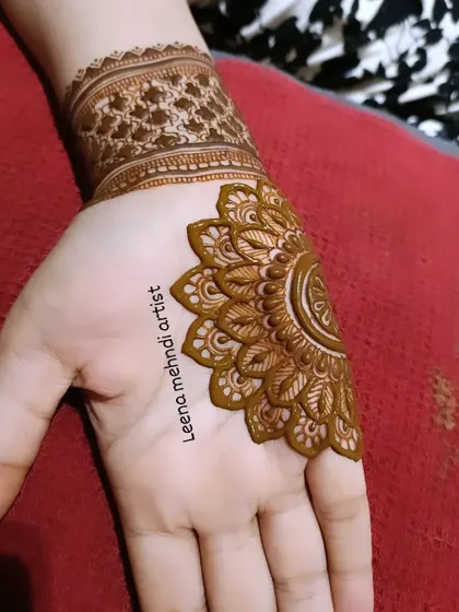 A unique half-mandala design on the palm. This style is modern and chic, and I teach the techniques for creating these intricate, symmetrical patterns.