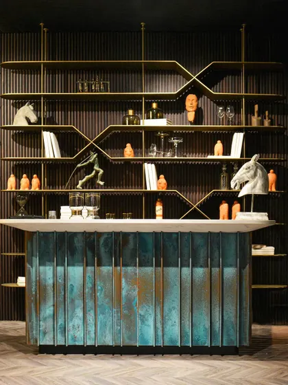 A centerpiece of our exhibit at the AD Design Show, this iconic bar unit makes a bold statement. The base is crafted from oxidized metal, creating a unique patina, while the sleek, distressed metal shelving system provides a perfect, contrasting backdrop.