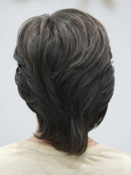 The back of the boy's haircut is expertly layered for a natural, tidy look.