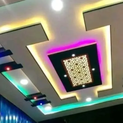 A modern design with a decorative twist. The central panel features a backlit jali pattern, surrounded by multi-colored cove lighting for a vibrant and stylish look.