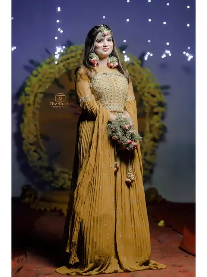 A full-length portrait of Simran in her elegant Haldi outfit. We capture the complete look, from the floral jewelry to the beautiful dress.