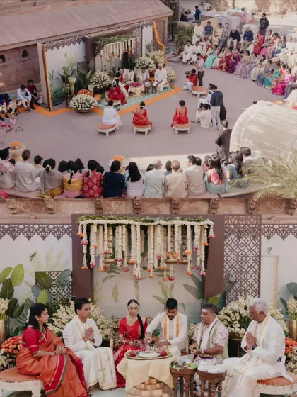 An overview of the South Indian wedding ceremony, capturing the couple, their families, and the guests in a single frame. This shows the full context and atmosphere of the ritual.