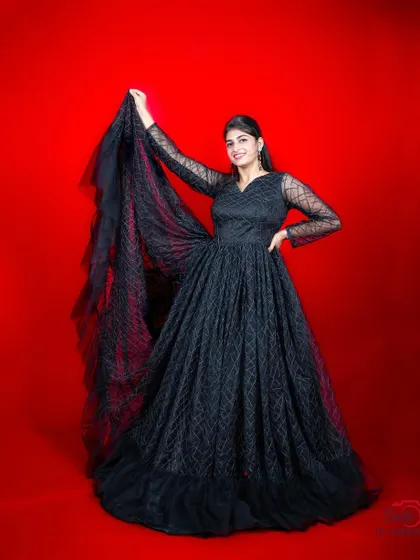 Another pose in our beautiful black patterned gown, showing its versatility.