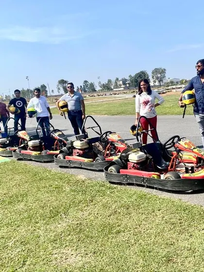 A group of friends posing with their karts after a fun session. Arrive with your friends and leave with great memories and a new level of confidence.