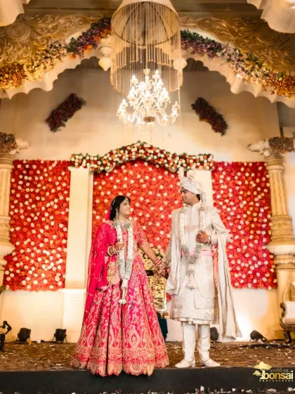 A wide shot of the couple on their magnificent wedding stage.