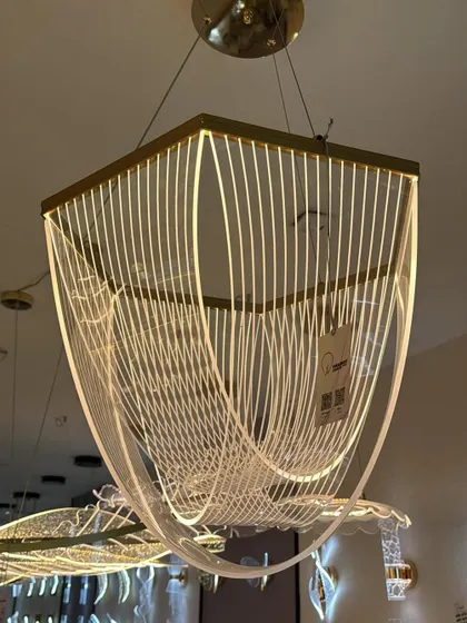 An example of modern art meeting light. This geometric chandelier uses flowing lines of light to create a sense of movement, perfect for a contemporary dining or living space.
