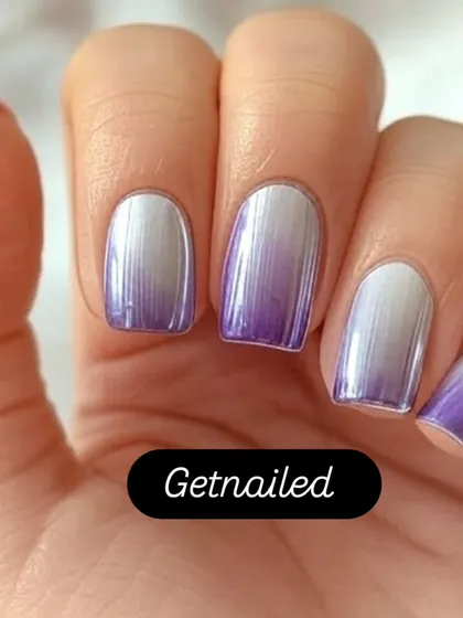 A stunning example of purple and silver chrome ombre. The colors blend seamlessly for a metallic, futuristic effect that is both bold and beautiful.